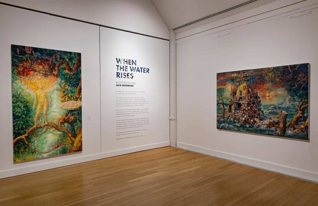 Gallery with two vibrant paintings depicting nature and water themes, titled "When the Water Rises" by Julie Heffernan.