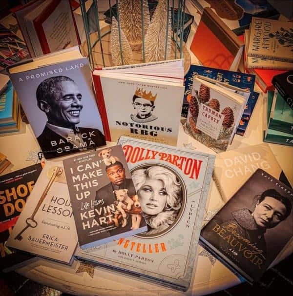 Books displayed on a table include titles by Barack Obama, Kevin Hart, Dolly Parton, and others.