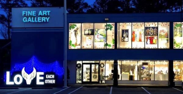 Fine Art Gallery exterior at night, large "LOVE EACH OTHER" sign with blue LED lights on the side.