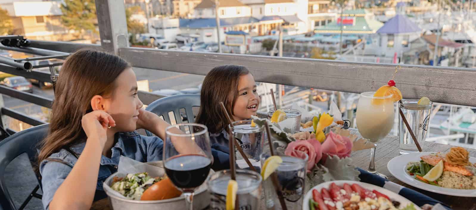 two little girls sitting at dinner