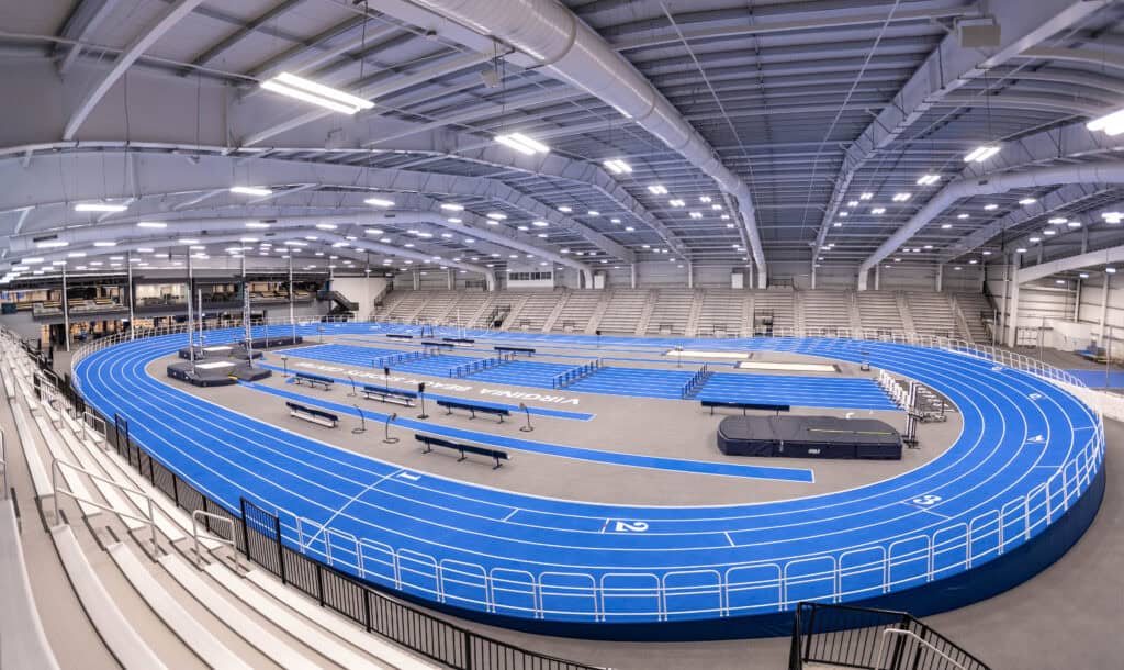 Virginia Beach Sports Center, an indoor athletic facility featuring a blue track, bleachers, and various sports equipment, designed for training and competitions.
