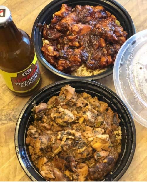 Two bowls of rice topped with different chicken dishes, alongside a bottle of pineapple ginger soda and a clear plastic lid, on a wooden surface.