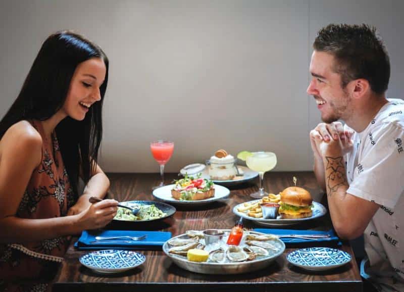 Couple bonding over dishes at the Atlantic on Pacific for a date night