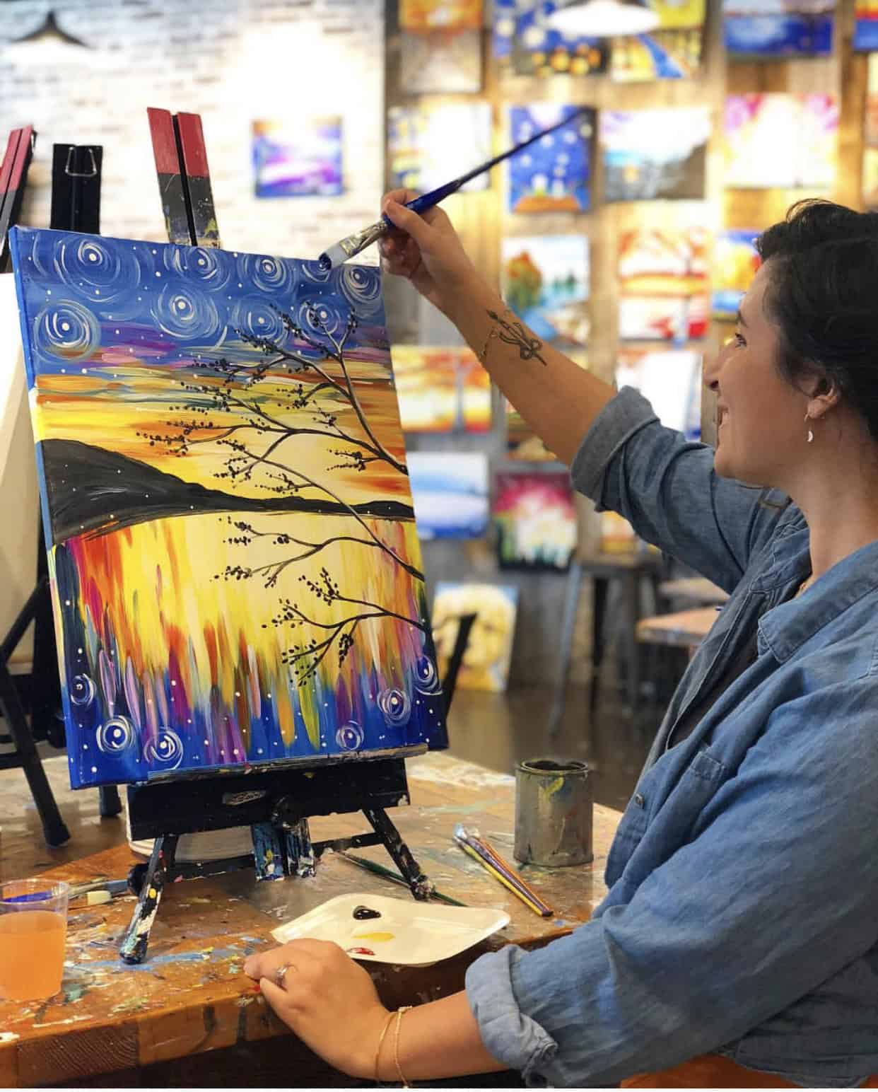 Woman Painting A Sunset At Muse Paint Bar In Virginia Beach
