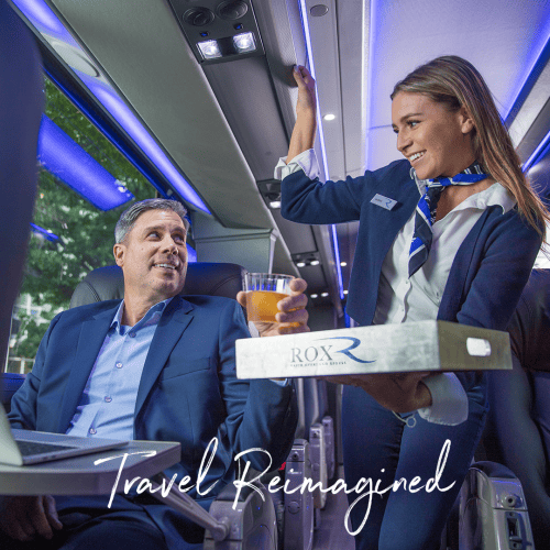 The Rox is pictured, a luxury motorcoach where a bus attendant is bringing a drink on a tray to a seated passenger. At the bottom of the photo it reads: "Travel Reimagined."
