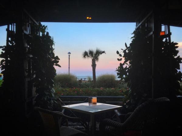 Catch 31 Dining With Water View in the Sunset and a table woth two cocktal
